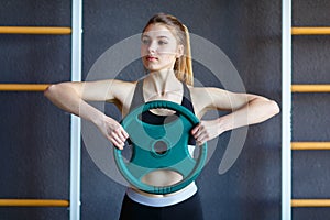 Young athletes girl does exercises at the gym. Sport concept.