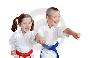 Young athletes in kimono beat a punch arm on a white background