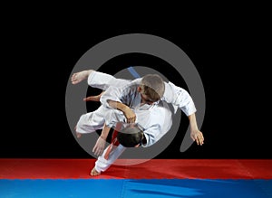 Young athletes in the sharp drop perform judo throw
