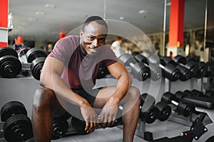 Young athletic African American man in the gym