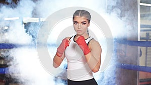 Young athletic female in sportive wear in ring