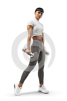 Young athletic girl with dumbbells in her hands