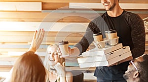 Young athletic man celebrating his b-day,treating friends with pizza and coffee.