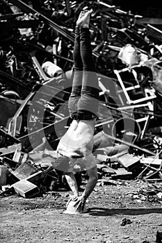 Young Athletic Man Doing Handstand at Industrial Junkyard