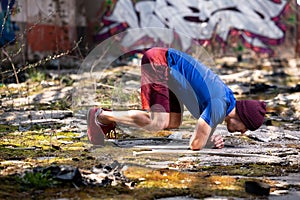 Young Athletic Man Doing Handstand at Warehouse