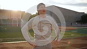 Young athletic man doing warm-up before exercise and jogging