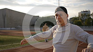 Young athletic man doing warm-up before exercise and jogging