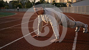 Young athletic man doing warm-up before exercise and jogging