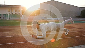 Young athletic man doing warm-up before exercise and jogging