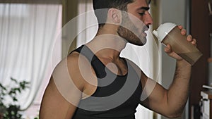 Young man drinking a smoothie drink or a protein shake