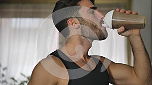 Young man drinking a smoothie drink or a protein shake