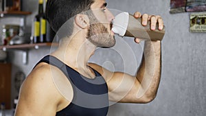 Young man drinking a smoothie drink or a protein shake