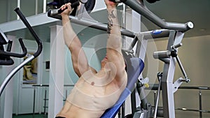 Young athletic man execute muscle exercises