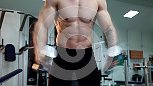 Young athletic man execute muscle exercises