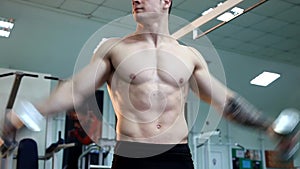 Young athletic man execute muscle exercises