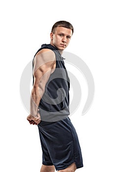 Young athletic man in sportswear shows muscles arms, triceps.