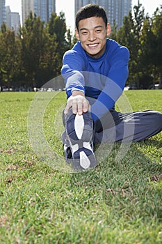 Young Athletic Man Stretching in Beijing Park