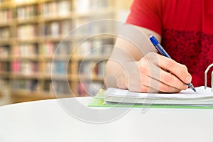 Young athletic man and student studying and writing notes.