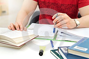 Young athletic man and student studying and writing notes.