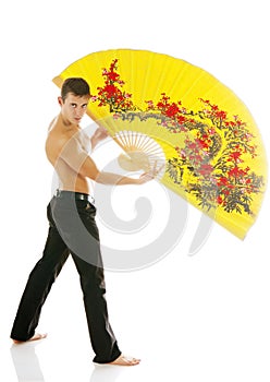 young athletic man with yellow fan