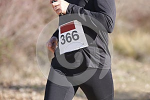 Young athletic runner on a cross country race. Outdoor circuit.