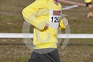 Young athletic runner on a cross country race. Outdoor circuit