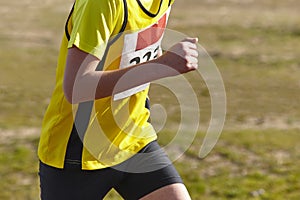 Young athletic runner on a cross country race. Outdoor circuit