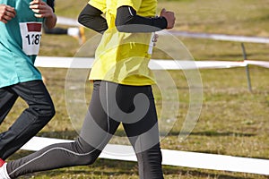 Young athletic runners on a cross country race. Outdoor circuit