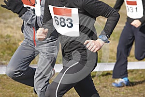 Young athletic runners on a cross country race. Outdoor circuit