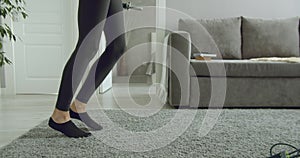 Young athletic woman doing exercises with dumbbells at home. Sports and training during self-isolation