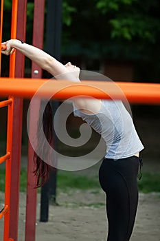 Young athletic woman doing stretching exercises