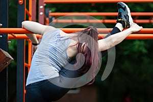 Young athletic woman doing stretching exercises