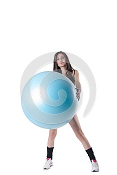 Young athletic woman exercised with a blue stability ball