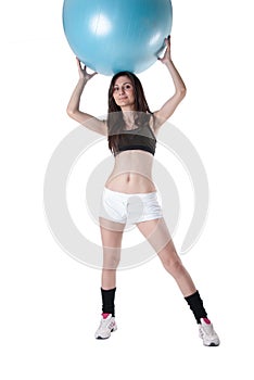 Young athletic woman exercised with a blue stability ball