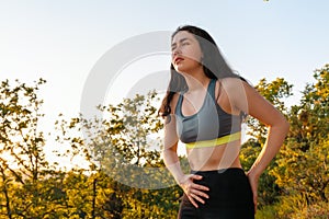 A young athletic woman experiences lower back or abdominal pain while exercising. The concept of sports and sports injuries