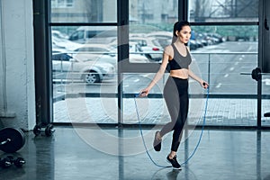 young athletic woman jumping with rope