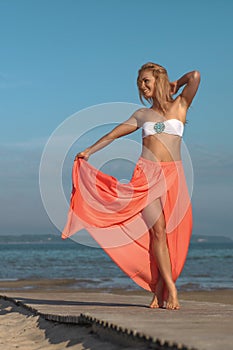 young athletic woman jumping and running on the beach