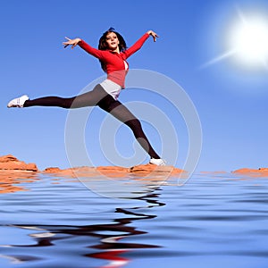 Young athletic woman jumping on the water