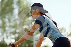 Young athletic woman riding a bike in the park