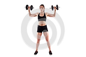 Young athletic woman working out with dumbbells