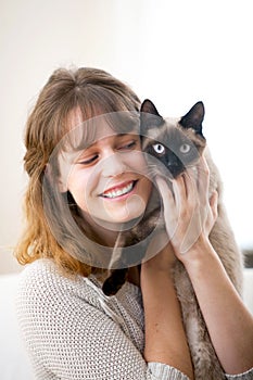 young atractive girl hugging her cat