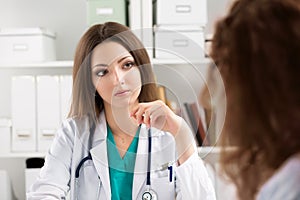 Young attentive doctor consulting patient