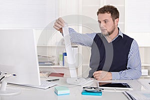 Young attractive accountant working with calculating machine.