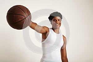 Young attractive African American model holding out a basketball