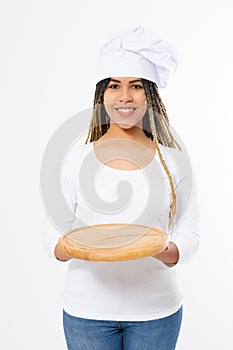 Young attractive african american woman in cooking hat holding empty wood pizza cutting board isolated on white background. Copy