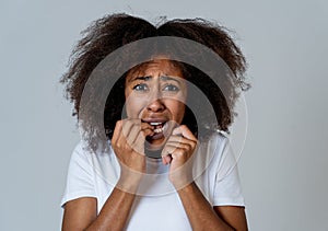 Young attractive african american woman looking scared and shocked. Human expressions and emotions