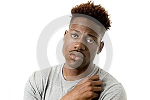 Young attractive afro american man on his 20s looking sad and depressed posing emotional