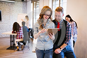 Young attractive architects discussing in modern office