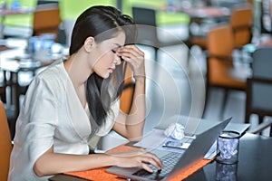 Young attractive Asian business woman sleeping, drowsing or taking a nap at her desk, Tired business woman accountant with bills