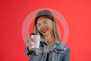 Young attractive asian girl offering coffee